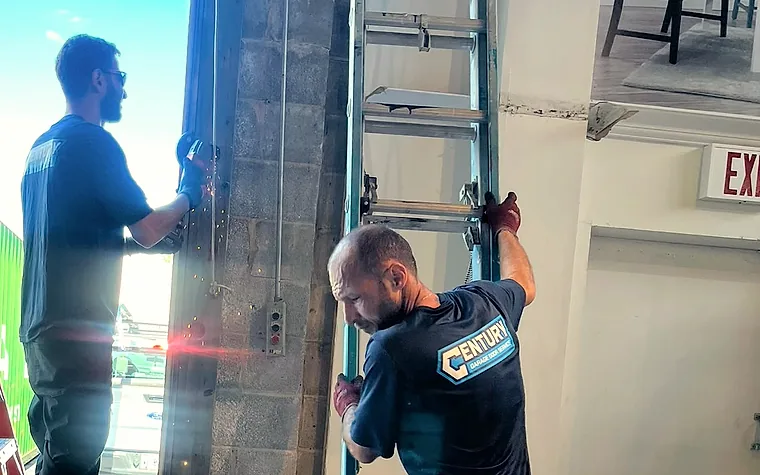 Century technicians installing a garage door track