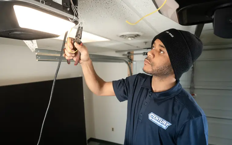 Century technician repairing a garage door opener