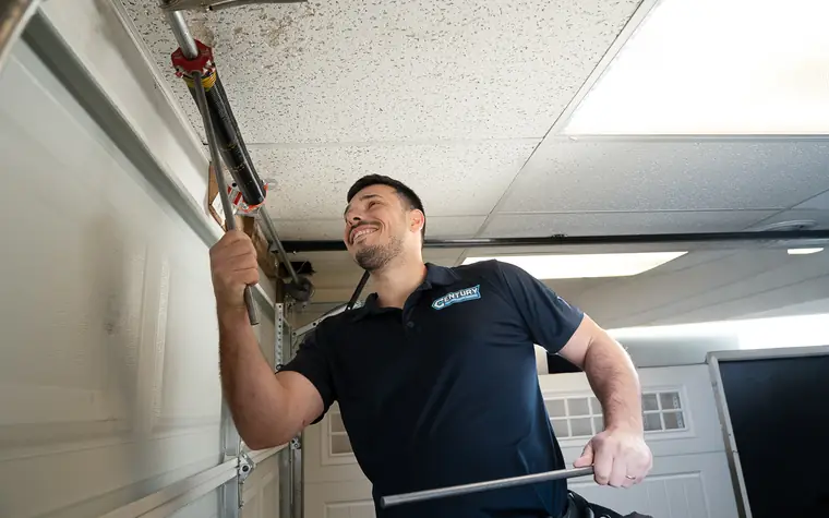 Century technician replacing a garage door torsion spring