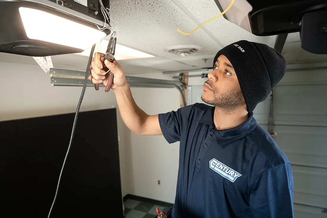 Century technician servicing a garage door opener motor head